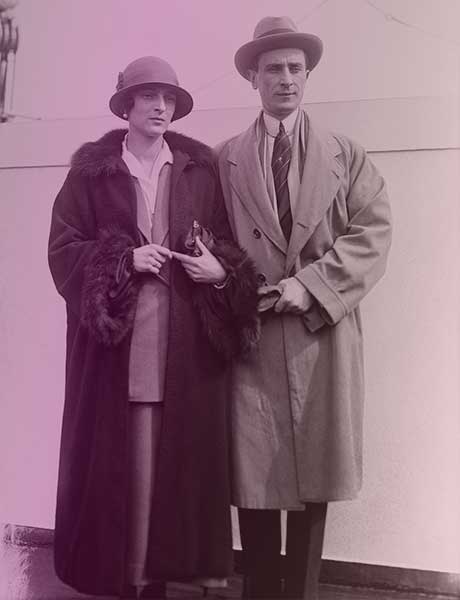Felix and Irina in exile. They're standing together in front of a building in Paris, wearing coats and hats, both looking more careworn than in their engagement photo.