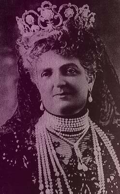 Queen Margherita's Musy tiara on the queen as an older woman. She's wearing it with a black lace veil, a high- necked black gown, and ropes of pearl necklaces.