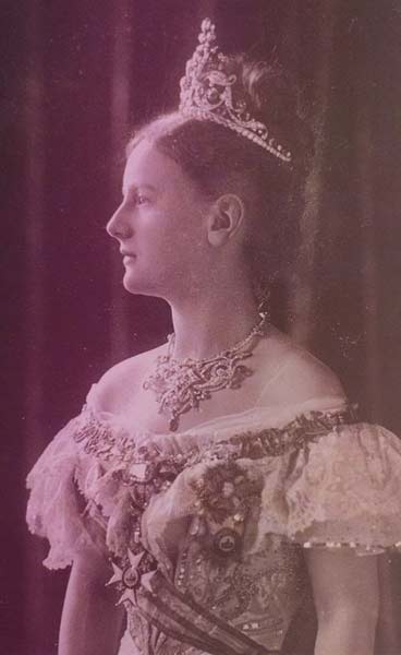 Queen Wilhelmina of the Netherlands in 1901, wearing a court dress, an ornate diamond necklace, and a tall tiara over upswept hair.